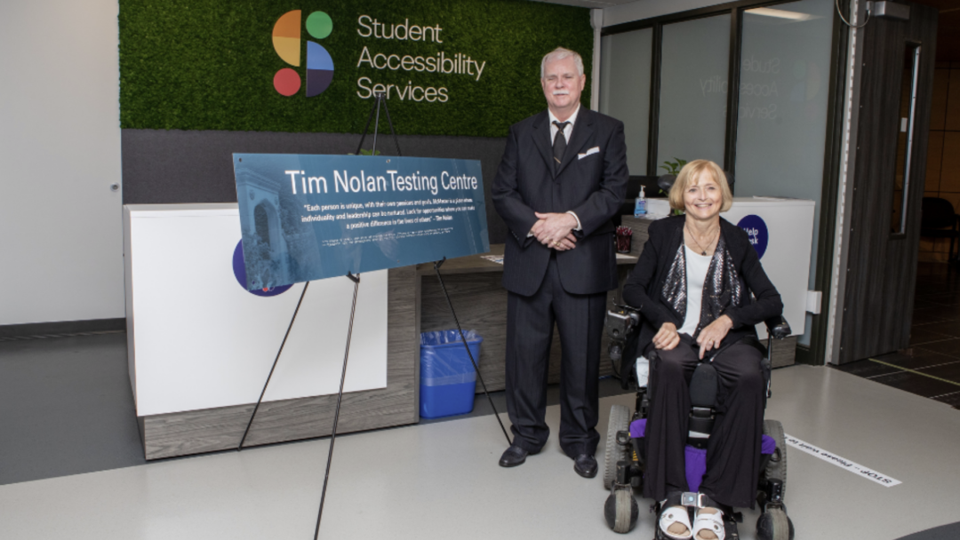 Tim Nolan (left), the former director of Student Accessibility Services (SAS)and Kim Nolan (right), posting out front of the SAS office.