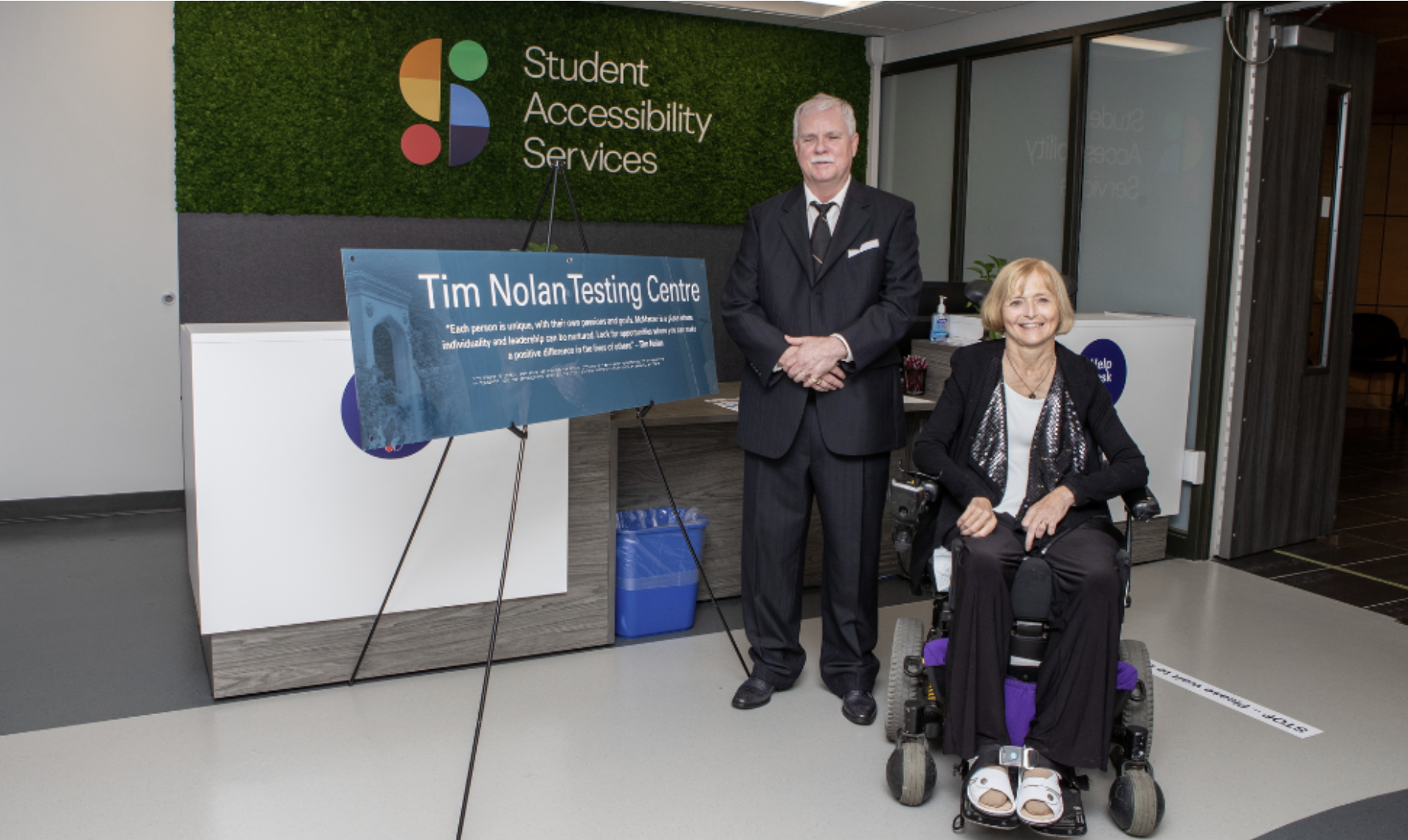 Tim Nolan (left), the former director of Student Accessibility Services (SAS)and Kim Nolan (right), posting out front of the SAS office.